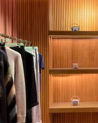 Off White: ribbed wood wall with a clothing rail